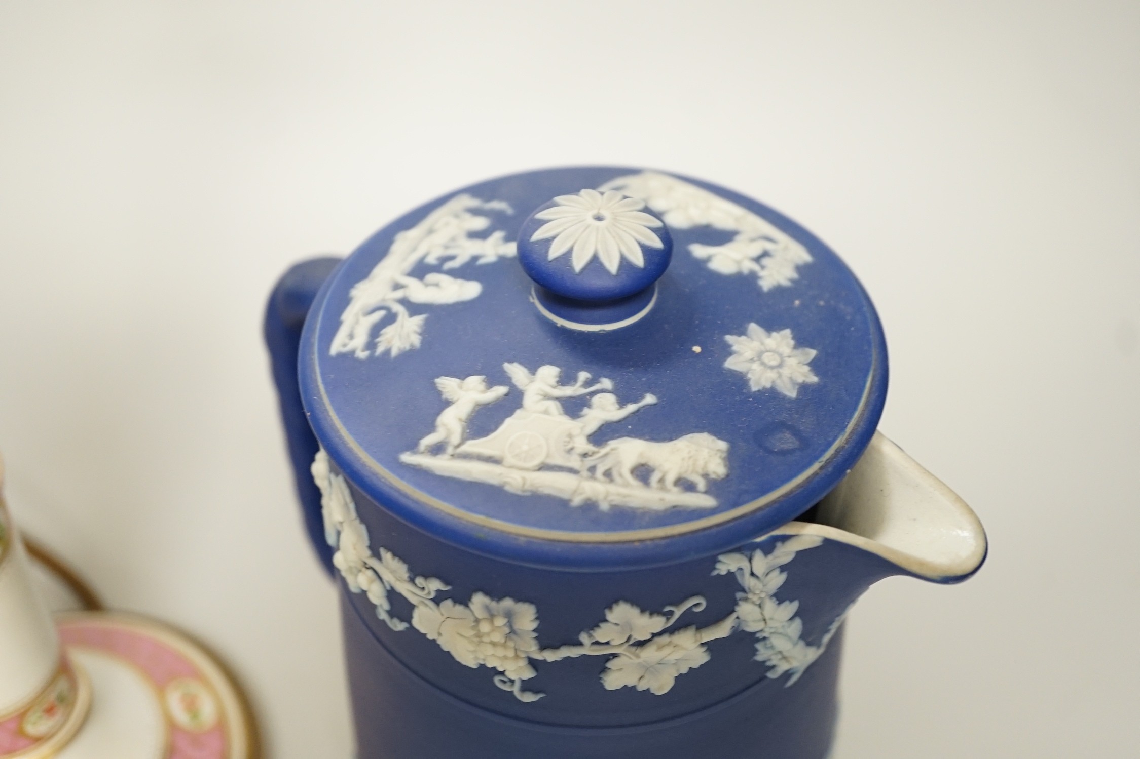 Three mid to late 19th century pieces of Wedgwood Jasperware, including a coffee pot and a small cache-pot, a pair of 19th century porcelain candlesticks converted into lamps